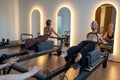 Studio reformer class dynamics, energetic group pilates reformer session with focused movement Royalty Free Stock Photo