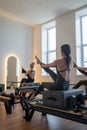 Studio reformer class dynamics, energetic group pilates reformer session with focused movement Royalty Free Stock Photo