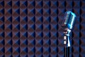 Studio retro condenser microphone on acoustic foam panel Royalty Free Stock Photo