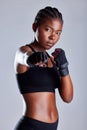 Studio, serious and black woman with gloves for boxing, portrait and ready for fight and competition. Purple background Royalty Free Stock Photo