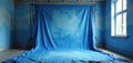 Studio setup with blue painted backdrop canvas for portraits, photography. Interior bright window, light, painted blue wall. Royalty Free Stock Photo