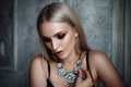 Studio shoot of blonde woman with jewelry. Fashion portrait. Royalty Free Stock Photo