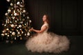 Teenager puts a ball on the Christmas tree