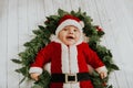 Christmas portrait of adorable newborn baby wearing Santa Claus` outfit Royalty Free Stock Photo