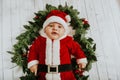 Christmas portrait of adorable newborn baby wearing Santa Claus` outfit Royalty Free Stock Photo