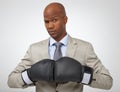 Ready to take on all business competition. Studio shot of an african american businessman wearing boxing gloves. Royalty Free Stock Photo