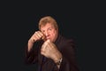 Studio shot of angry senior businessman with fist raise against dark background Royalty Free Stock Photo