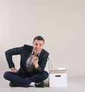 Studio shot of attractive positive businessman with office stuff