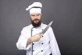 Studio shot of a bearded chef holding a big sharp knife Royalty Free Stock Photo