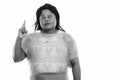 Studio shot of fat black African woman thinking while pointing finger up Royalty Free Stock Photo