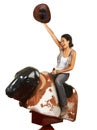 Yeehaw. Studio shot of a beautiful young woman riding a mechanical bull against a white background. Royalty Free Stock Photo