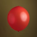 Red Shiny Balloon Against An Olive Green Background