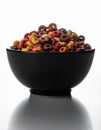 Studio Shot of Black Bowl Filled with Colorful Cereal on White Background Royalty Free Stock Photo