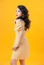 Studio shot of blithesome girl isolated on yellow background