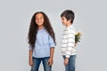 Studio shot of a young boy giving flowers to a girl, isolated Royalty Free Stock Photo