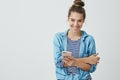 Studio shot carefree tender attractive young confident woman hair combed hairbun smiling, laughing having fun holding