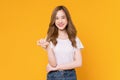 Studio shot of cheerful beautiful Asian woman in white t-shirt and stand on yellow background