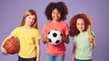 Studio Shot Of Children With Sports Equipment For Soccer Basketball Baseball On Purple Background