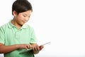 Studio Shot Of Chinese Boy With Digital Tablet Royalty Free Stock Photo