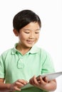 Studio Shot Of Chinese Boy With Digital Tablet Royalty Free Stock Photo
