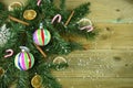 Christmas photography image with green tree branch leaves cinnamon orange slices and colorful bauble decorations and snow Royalty Free Stock Photo