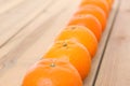 Line of citrus tankan against wooden background