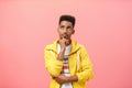 Studio shot of concerned thoughtful troubled young dark-skinned guy with beard and afro hairstyle frowning touching chin Royalty Free Stock Photo