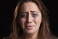 Studio Shot Of Crying Young Woman With Smudged Eye Make Up