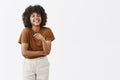 Studio shot of cute african american woman with afro hairstyle in trendy summer outfit having fun laughing out loud from