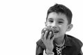 Studio shot of cute happy boy smiling and eating apple Royalty Free Stock Photo