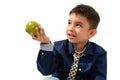 Studio shot of cute happy boy smiling and giving green apple whi Royalty Free Stock Photo