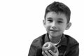 Studio shot of cute happy boy smiling and holding red apple Royalty Free Stock Photo