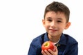 Studio shot of cute happy boy smiling and holding red apple Royalty Free Stock Photo