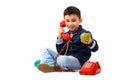 Studio shot of cute happy boy smiling and talking on old telepho Royalty Free Stock Photo