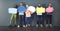 Speak your mind. Studio shot of a diverse group of people holding up speech bubbles against a gray background.