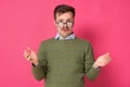 Clueless man with glasses having confused puzzled look, shrugging shoulders as he does not know Royalty Free Stock Photo