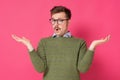Clueless man with glasses having confused puzzled look, shrugging shoulders as he does not know Royalty Free Stock Photo