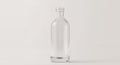Empty clear glass bottle with a screw neck, on a white background in studio shot. Royalty Free Stock Photo