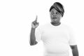 Studio shot of fat black African woman pointing finger up while thinking ready for gym Royalty Free Stock Photo