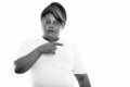 Studio shot of fat black African woman pointing to the side while thinking ready for gym Royalty Free Stock Photo