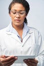 Studio Shot Of Female Laboratory Technician Working With Digital Tablet