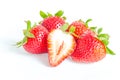 Studio shot four whole organic strawberries with a half cut isolated on white Royalty Free Stock Photo