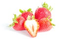 Studio shot four whole organic strawberries with a half cut isolated on white Royalty Free Stock Photo