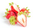 Studio shot four whole organic strawberries with two half cuts isolated on white Royalty Free Stock Photo