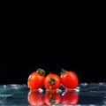 Studio shot with freeze motion of cherry tomatoes Royalty Free Stock Photo