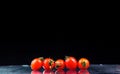 Studio shot with freeze motion of cherry tomatoes Royalty Free Stock Photo