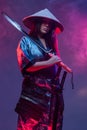 Futuristic woman samurai with katana against colorful background