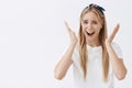 Studio shot of girl panicking, having no clue what to do with her life. Portrait of nervous funny european female with