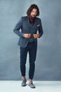 So much style. Studio shot of a handsome and dapper young man posing against a grey background.