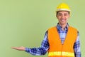 Happy multi ethnic man construction worker showing something Royalty Free Stock Photo